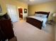 Bedroom with a large bed, neutral carpet and ensuite bathroom creating a relaxing and private retreat at 6016 Southland Dr, Stone Mountain, GA 30087