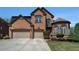 Beautiful two-story brick home featuring a three-car garage and manicured landscaping at 6016 Southland Dr, Stone Mountain, GA 30087