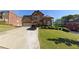 Charming brick home with a three-car garage, well-manicured lawn, and beautiful landscaping at 6016 Southland Dr, Stone Mountain, GA 30087
