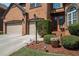 Up close view of a beautiful red brick home featuring manicured bushes and a well-maintained lawn at 6016 Southland Dr, Stone Mountain, GA 30087