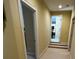 Hallway featuring beige carpet, tan walls, and stairs leading to the upper level at 6016 Southland Dr, Stone Mountain, GA 30087