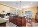 Open-concept kitchen with island, stainless appliances, and hardwood floors at 6016 Southland Dr, Stone Mountain, GA 30087