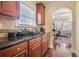A cozy kitchen features granite countertops and stainless steel appliances near the sunlit window at 6016 Southland Dr, Stone Mountain, GA 30087