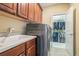 Laundry room with modern appliances, cabinets, and a doorway to a walk-in closet for easy organization at 6016 Southland Dr, Stone Mountain, GA 30087