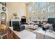 Elegant living room with fireplace, two-story windows, and hardwood floors at 6016 Southland Dr, Stone Mountain, GA 30087