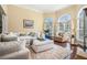 Bright living room with large arched windows and a comfortable sectional sofa at 6016 Southland Dr, Stone Mountain, GA 30087