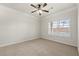 Bright bedroom featuring a ceiling fan and a large window with blinds at 1850 Cotillion Dr # 1008, Atlanta, GA 30338