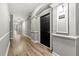 Long hallway with neutral paint, white trim, and wood-look flooring leading to unit 1008 at 1850 Cotillion Dr # 1008, Atlanta, GA 30338