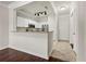 Open kitchen with white cabinets, breakfast bar, and stainless steel appliances flowing into living area at 1850 Cotillion Dr # 1008, Atlanta, GA 30338