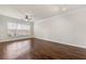 Spacious living room featuring wood floors, ceiling fan, and large window providing natural light at 1850 Cotillion Dr # 1008, Atlanta, GA 30338