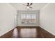 Open living room features wood floors, a ceiling fan, and a sliding glass door to outdoor patio at 1850 Cotillion Dr # 1008, Atlanta, GA 30338