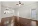 Open floor plan with hardwood floors connecting living area to kitchen with stainless appliances at 1850 Cotillion Dr # 1008, Atlanta, GA 30338