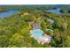 Wonderful aerial view showcases the pool, clubhouse, and lake views surrounded by lush, mature trees at 216 Crescent Moon Way, Canton, GA 30114