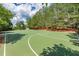 Outdoor basketball court with blue skies and mature trees to the background at 216 Crescent Moon Way, Canton, GA 30114