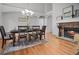 Elegant dining room featuring hardwood floors, a stone fireplace, and stylish furnishings at 216 Crescent Moon Way, Canton, GA 30114