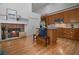 Open kitchen boasts a stone fireplace, stainless steel appliances, and an eat-in island at 216 Crescent Moon Way, Canton, GA 30114