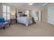 Relaxing main bedroom with a four-poster bed, cozy seating and a spa-like ensuite at 216 Crescent Moon Way, Canton, GA 30114