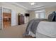 Bright main bedroom boasts tray ceilings, plush carpet and access to a balcony at 216 Crescent Moon Way, Canton, GA 30114