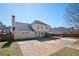 View of the home's rear exterior and large concrete patio at 3090 Perch Overlook Sw, Marietta, GA 30008