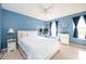 Cozy bedroom with blue walls, carpet, and ample natural light from two windows at 3090 Perch Overlook Sw, Marietta, GA 30008
