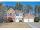 Charming two-story brick and siding home with a well-manicured lawn and attached two-car garage at 3090 Perch Overlook Sw, Marietta, GA 30008