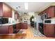 Stylish kitchen featuring stainless steel appliances, granite countertops, and cherry wood cabinets at 3090 Perch Overlook Sw, Marietta, GA 30008