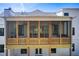 Spacious screened porch with wood railings and ceiling fans overlooks backyard at 555 Lower Birmingham Rd, Canton, GA 30115