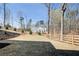 Spacious backyard with a freshly landscaped hillside, bordered by a wooden fence at 555 Lower Birmingham Rd, Canton, GA 30115
