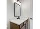 Modern bathroom vanity with wood cabinets, black hardware, quartz countertop, and decorative mirror at 555 Lower Birmingham Rd, Canton, GA 30115