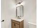 Bathroom with a wooden vanity, black faucet and lighting, and a white quartz countertop at 555 Lower Birmingham Rd, Canton, GA 30115