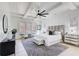 Bright bedroom boasts a stylish ceiling fan, tray ceiling, natural light and elegant decor at 555 Lower Birmingham Rd, Canton, GA 30115