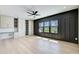 Bedroom featuring wood panel accent wall, light wood flooring and custom cabinets and shelving at 555 Lower Birmingham Rd, Canton, GA 30115