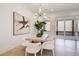 Dining room features a modern chandelier, seating for eight, and a view of the screened porch at 555 Lower Birmingham Rd, Canton, GA 30115