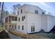 Exterior rear view of a modern farmhouse with a screened porch and walk out basement at 555 Lower Birmingham Rd, Canton, GA 30115