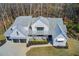 Stunning two-story home with a metal roof, a covered porch with wooden columns, and a well-manicured lawn and landscaping at 555 Lower Birmingham Rd, Canton, GA 30115