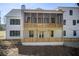 Back exterior of a white two-story house with a wooden screen porch at 555 Lower Birmingham Rd, Canton, GA 30115