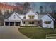 Charming home with a three-car garage, wooden accents on the porch, and a beautifully landscaped front yard at 555 Lower Birmingham Rd, Canton, GA 30115