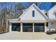 Three car garage with black garage doors and wooden beam details at 555 Lower Birmingham Rd, Canton, GA 30115