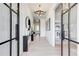 Hallway with modern light fixture, art, console table and doors to adjacent rooms at 555 Lower Birmingham Rd, Canton, GA 30115