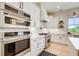 Kitchen boasts stainless steel appliances, white cabinets, and modern gas cooktop at 555 Lower Birmingham Rd, Canton, GA 30115