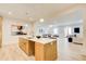 Open kitchen with a large island and sink, flowing into a bright living area at 555 Lower Birmingham Rd, Canton, GA 30115