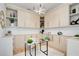 Home office features built-in cabinets, modern chandelier, and glass top desk at 555 Lower Birmingham Rd, Canton, GA 30115
