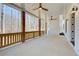Covered patio with ceiling fans and wooden posts, overlooking the wooded backyard at 555 Lower Birmingham Rd, Canton, GA 30115