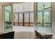 View of screened porch with ceiling fan, grill, and wooded view at 555 Lower Birmingham Rd, Canton, GA 30115