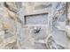 Luxurious shower with stone-look tile walls and a built-in niche for storage at 555 Lower Birmingham Rd, Canton, GA 30115
