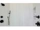 Modern shower with black fixtures and white tile and a built-in shelf at 555 Lower Birmingham Rd, Canton, GA 30115