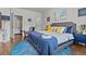 Well-lit primary bedroom featuring hardwood floors, modern decor, and a comfortable king bed at 6028 Providence Dr, Union City, GA 30291