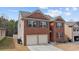 Charming two-story brick home features a well-maintained yard and a two-car garage at 6028 Providence Dr, Union City, GA 30291