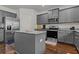 A kitchen with stainless steel appliances, an island, granite countertops and grey cabinets at 6028 Providence Dr, Union City, GA 30291