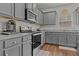 Well-equipped kitchen with gray cabinets, stainless steel appliances, and modern countertops at 6028 Providence Dr, Union City, GA 30291